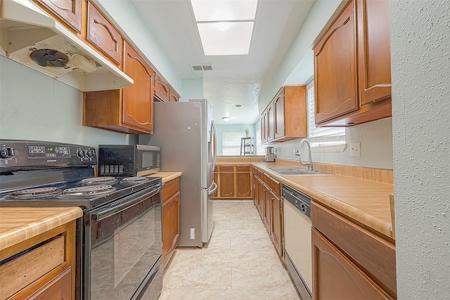 kitchen with white dishwasher, black range with electric stovetop, and sink