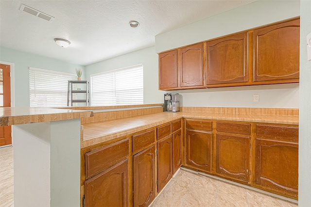 kitchen featuring kitchen peninsula and a textured ceiling