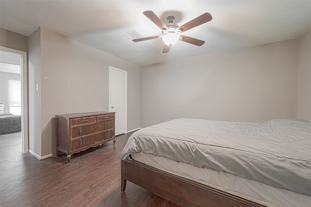 bedroom with dark wood-type flooring and ceiling fan