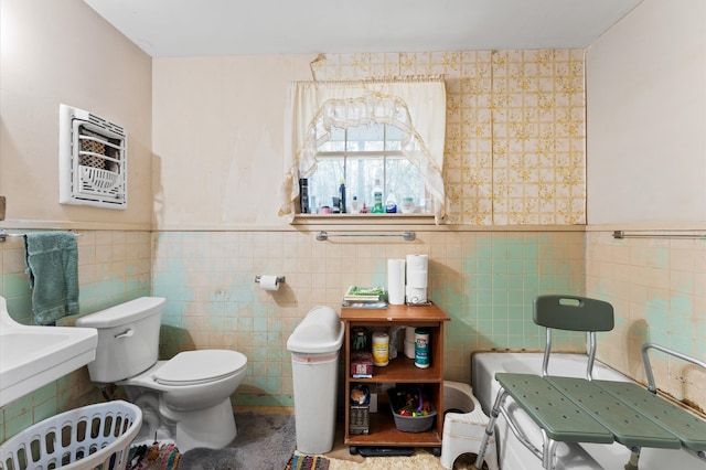 bathroom featuring toilet and tile walls