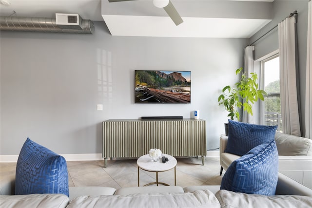 living room with radiator heating unit, light tile patterned floors, and ceiling fan