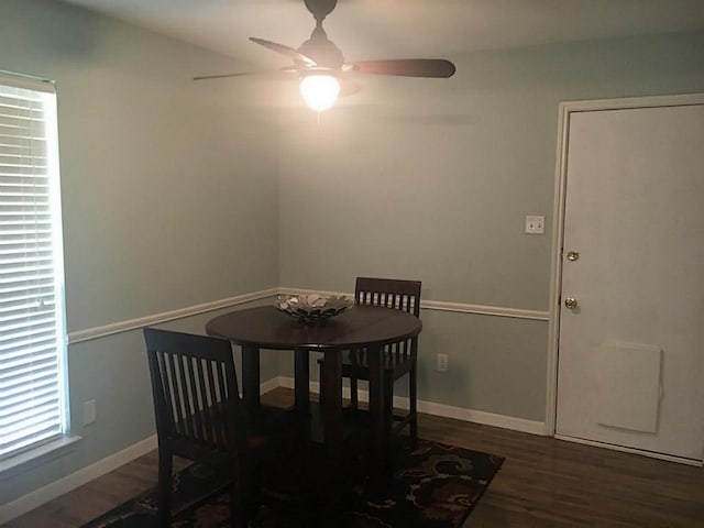 dining area with ceiling fan and dark hardwood / wood-style floors