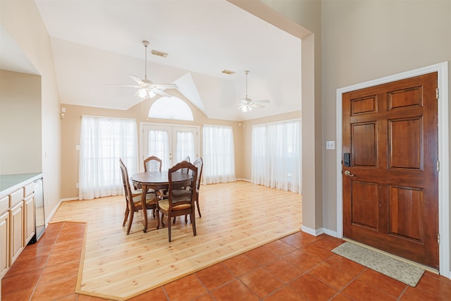 dining area with lofted ceiling, ceiling fan, wood-type flooring, and french doors