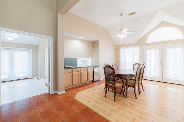 dining space featuring french doors, a wealth of natural light, lofted ceiling, and ceiling fan