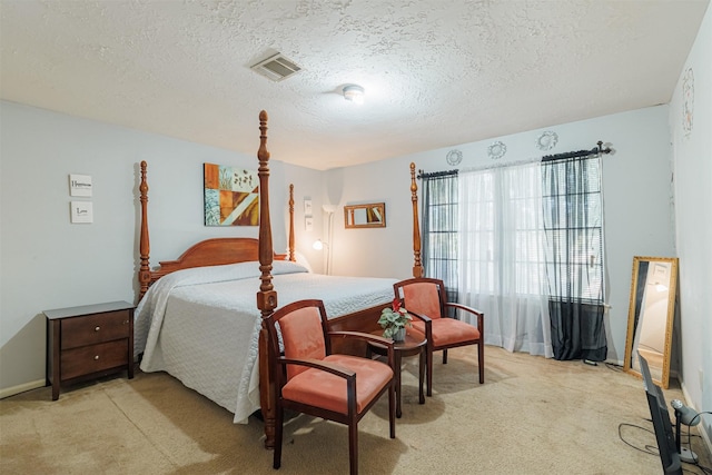 carpeted bedroom featuring a textured ceiling