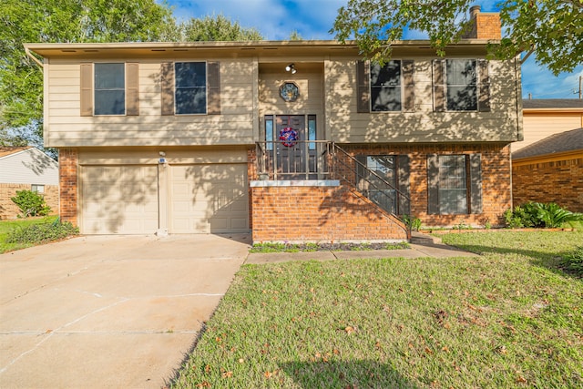 split foyer home featuring a garage and a front lawn