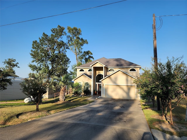 view of front of property featuring a front lawn and a garage