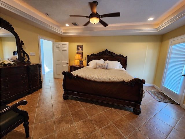 tiled bedroom with ceiling fan and a raised ceiling