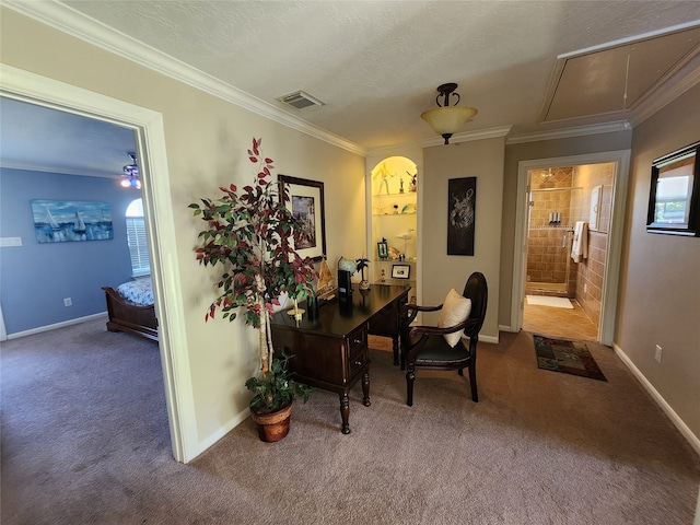 home office with a textured ceiling, carpet flooring, and ornamental molding