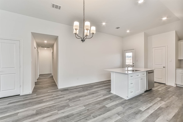 kitchen featuring a kitchen island with sink, hanging light fixtures, white cabinets, dishwasher, and light hardwood / wood-style flooring