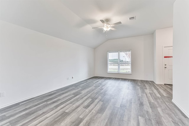 unfurnished room featuring light hardwood / wood-style floors, ceiling fan, and vaulted ceiling