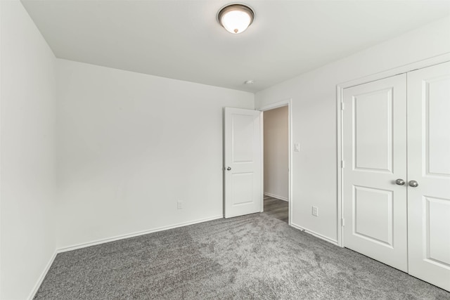 unfurnished bedroom featuring carpet and a closet