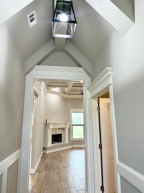 corridor with beamed ceiling, hardwood / wood-style flooring, and coffered ceiling