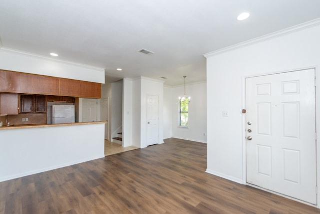 interior space featuring dark wood-type flooring, crown molding, and white refrigerator