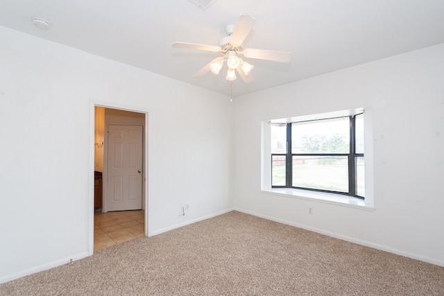 unfurnished room with ceiling fan and light carpet