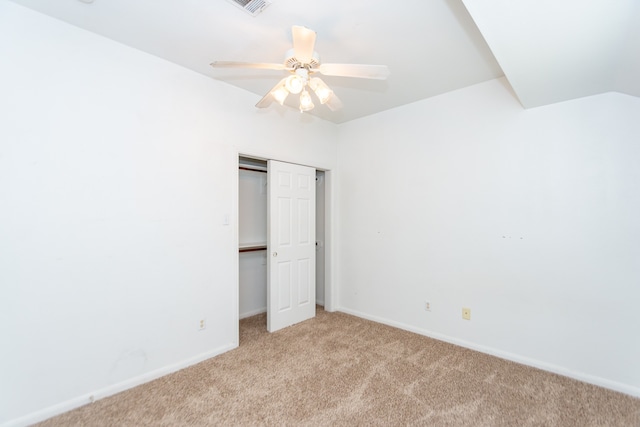 unfurnished bedroom featuring light colored carpet, ceiling fan, and a closet