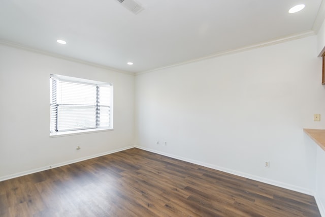 unfurnished room with ornamental molding and dark wood-type flooring