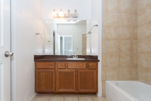 bathroom with tile patterned flooring, vanity, and tiled shower / bath combo