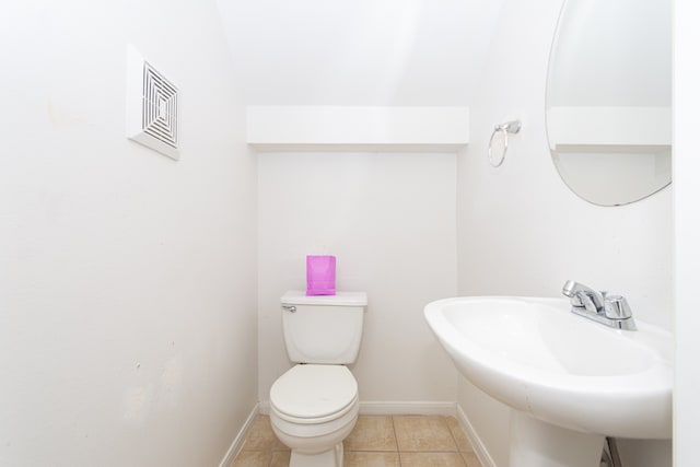 bathroom featuring toilet, sink, and tile patterned floors