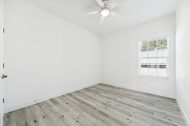 empty room with ceiling fan and light hardwood / wood-style flooring