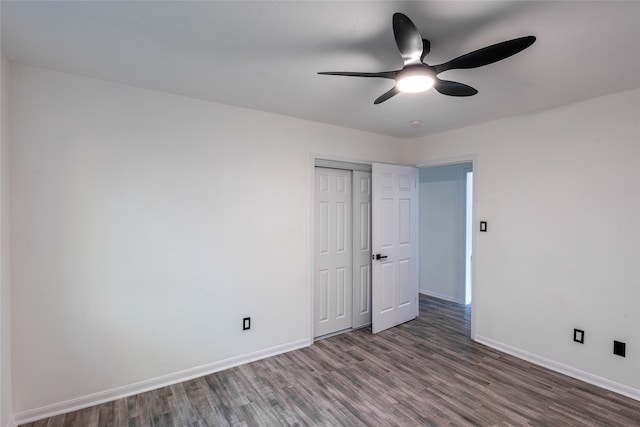 spare room with dark hardwood / wood-style flooring and ceiling fan