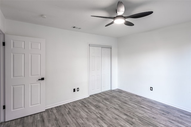 unfurnished bedroom featuring a closet, light wood-type flooring, and ceiling fan