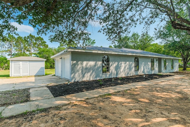 view of side of property with a storage unit and a garage