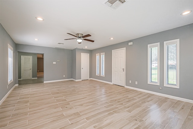 spare room with ceiling fan and light hardwood / wood-style floors