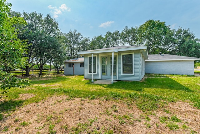 back of property with a lawn