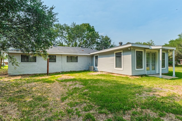 rear view of property with a yard