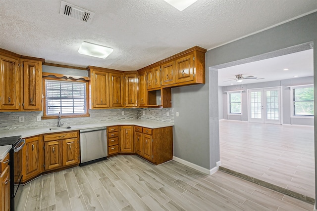 kitchen featuring a wealth of natural light, black range with electric stovetop, light hardwood / wood-style flooring, and dishwasher