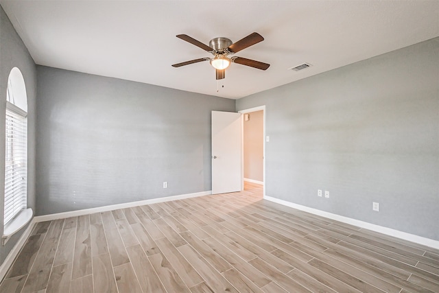 empty room with light hardwood / wood-style flooring and ceiling fan