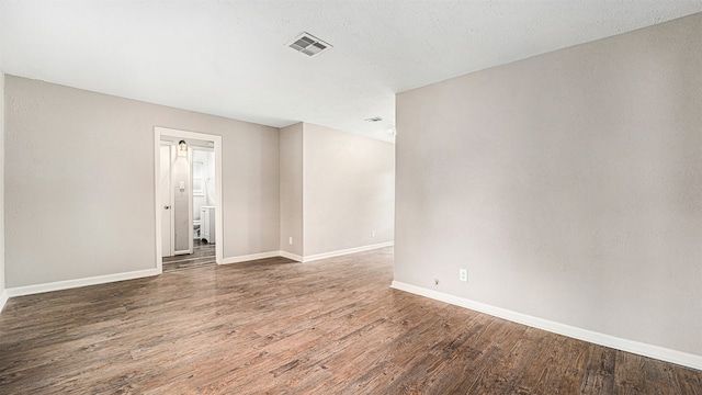 empty room with dark hardwood / wood-style floors