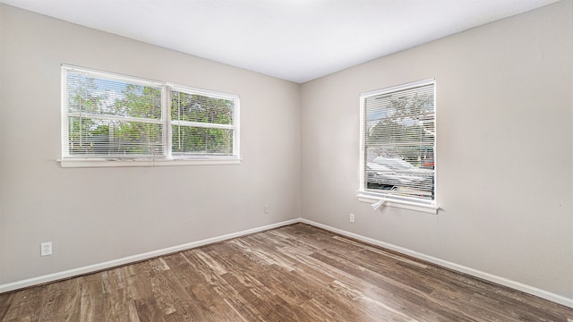 empty room with hardwood / wood-style flooring