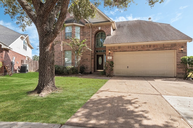 view of front of property featuring a garage, central AC unit, and a front lawn