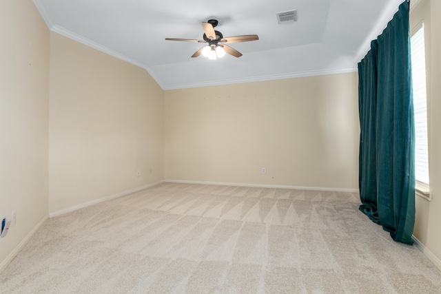 spare room with ornamental molding, light colored carpet, ceiling fan, and vaulted ceiling