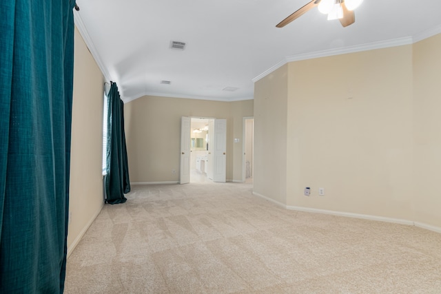 carpeted spare room with lofted ceiling, ceiling fan, and crown molding