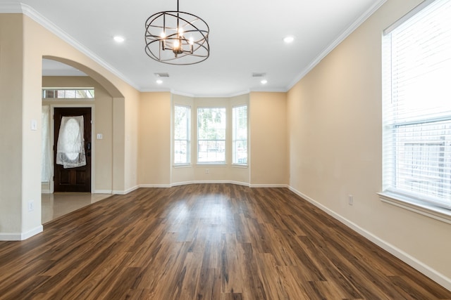 interior space featuring dark wood-type flooring, crown molding, and a notable chandelier