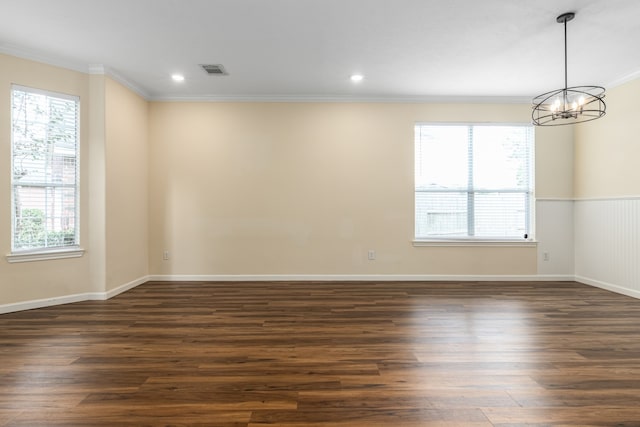 unfurnished room featuring ornamental molding, a notable chandelier, and dark hardwood / wood-style floors