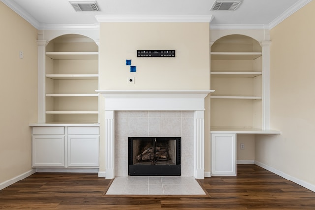 interior details featuring hardwood / wood-style floors, crown molding, and a fireplace