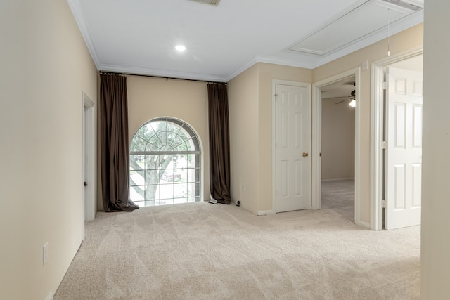 unfurnished room with light colored carpet, ceiling fan, and crown molding