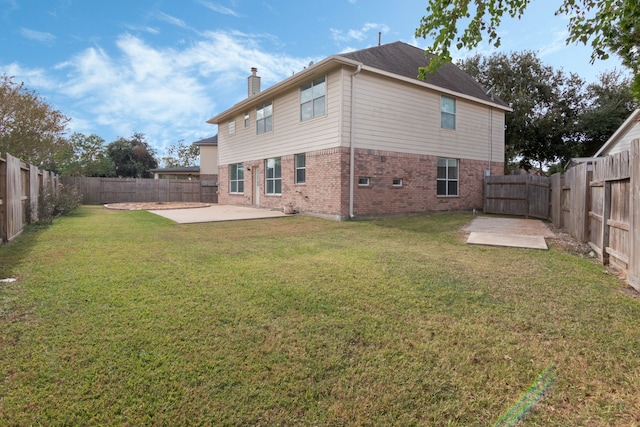 back of house featuring a patio and a lawn