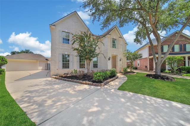 view of front of house featuring a garage and a front lawn