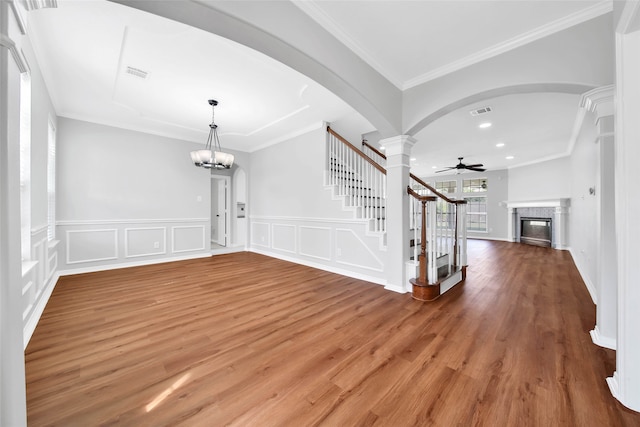 entrance foyer featuring ornamental molding, ceiling fan with notable chandelier, and hardwood / wood-style floors