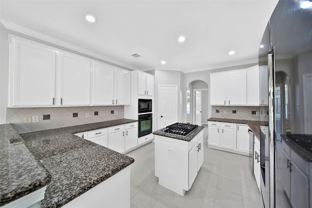 kitchen featuring white cabinetry, a center island, and black appliances