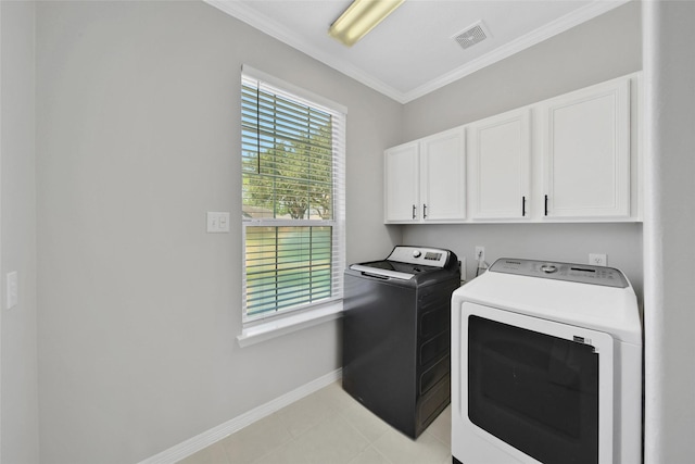 laundry area with cabinets, washing machine and dryer, and crown molding