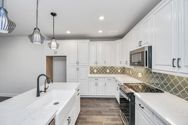 6804 Westview Dr Unit 3405, Houston, TX 77055 - kitchen featuring stainless steel microwave, electric stove, white cabinetry, a sink, and tasteful backsplash