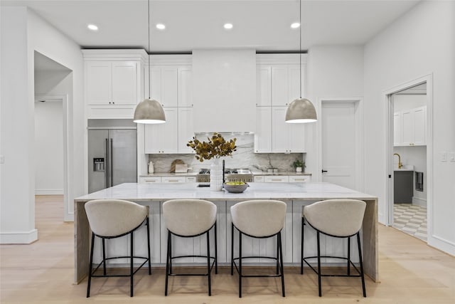 kitchen with white cabinetry, a spacious island, and appliances with stainless steel finishes