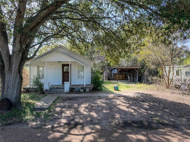 view of front of property featuring a shed and covered porch