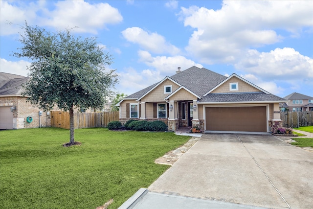 view of front of home featuring a garage and a front yard